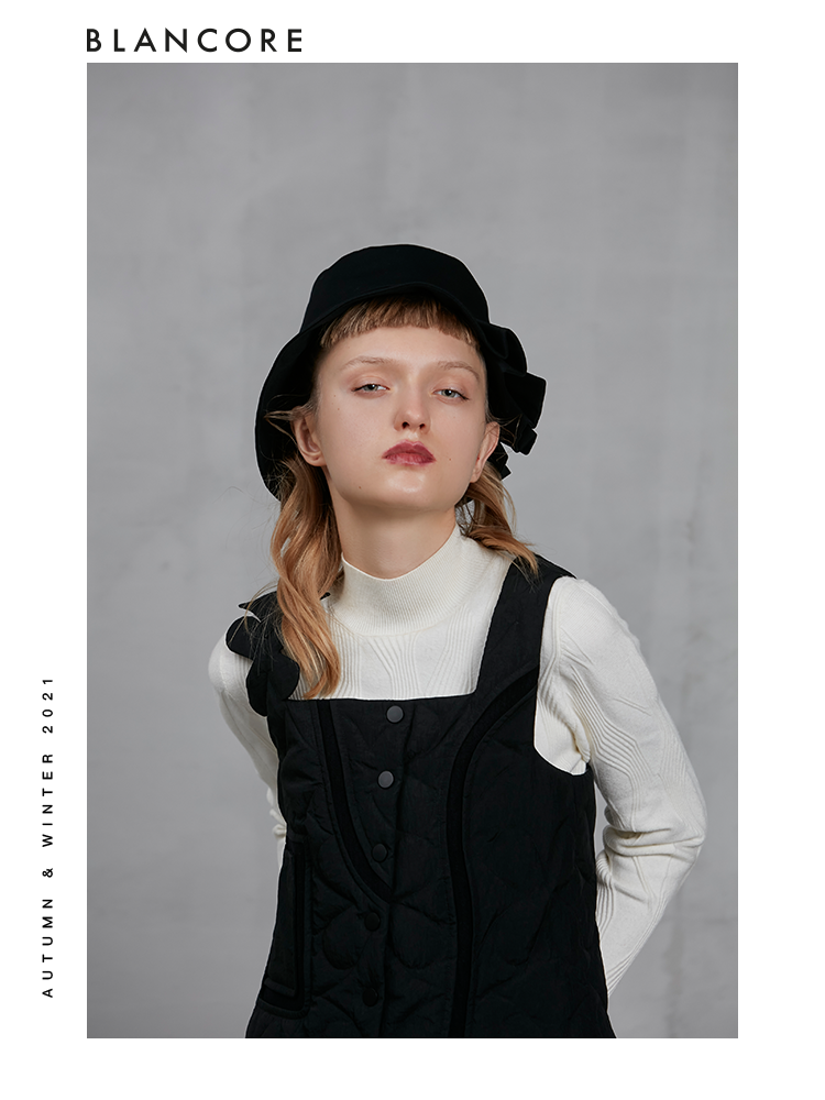 BOW BACK DOWN VEST WITH ASYMMETRIC SHOULDER DETAIL
